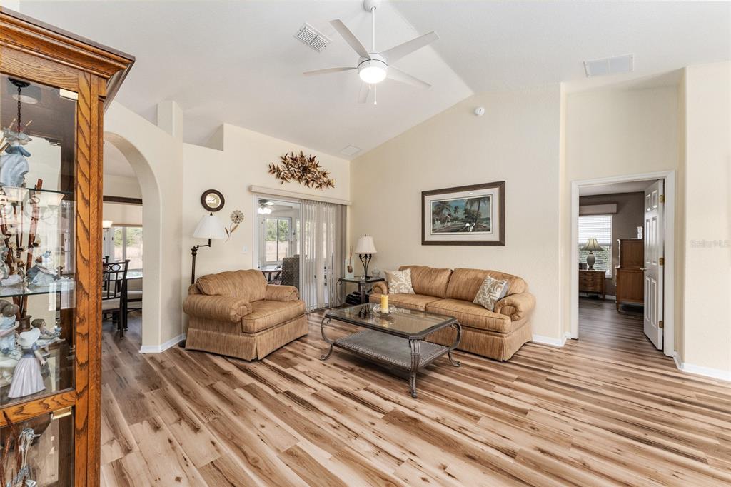 9910 Southeast 138th Loop Summerfield, FL 34491 - Photo 10 of 69 a living room with furniture a large window and a rug