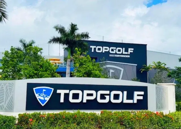 a street sign that is sitting on a brick wall