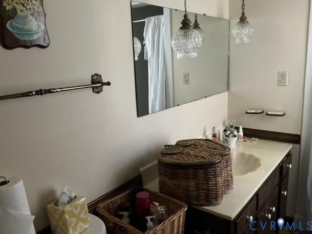 9525 Alfaree Road Richmond, VA 23237 - Photo 16 of 20 a bathroom with a granite countertop sink a toilet and shower