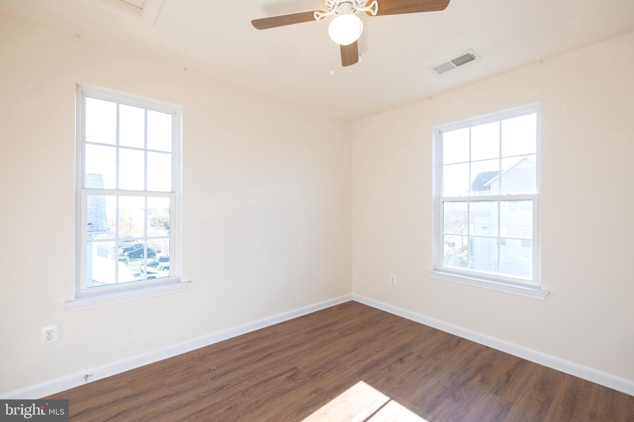 202 Fiesta Drive Stephenson, VA 22656 - Photo 13 of 33 an empty room with wooden floor fan and windows