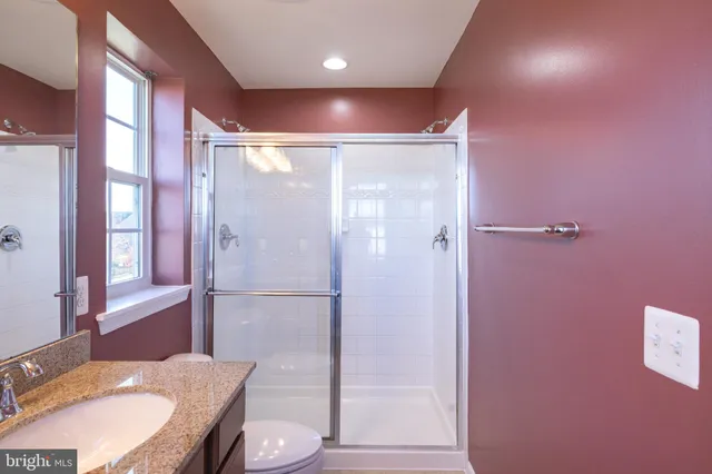 a bathroom with a granite countertop sink a window and a mirror