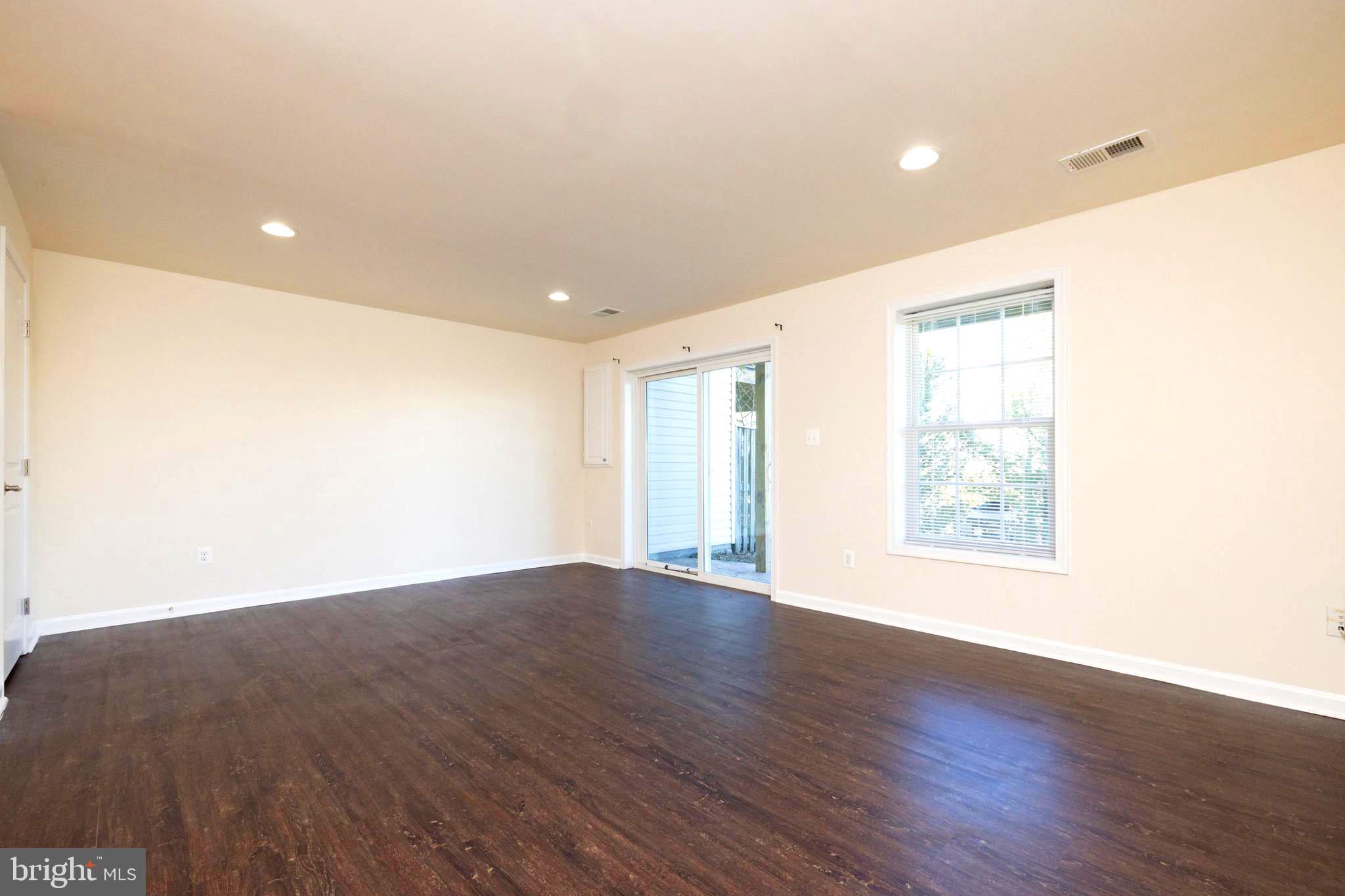202 Fiesta Drive Stephenson, VA 22656 - Photo 20 of 33 an empty room with wooden floor and windows