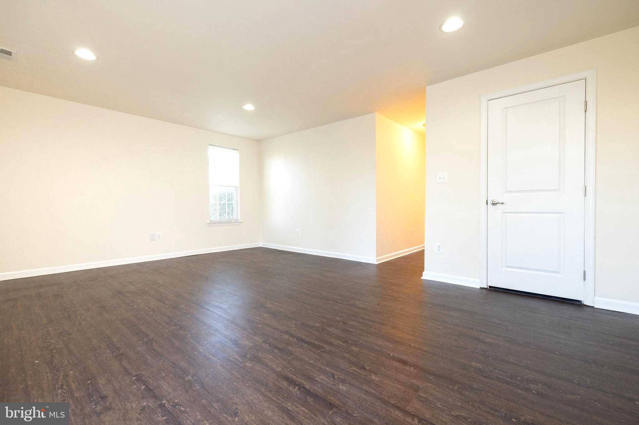202 Fiesta Drive Stephenson, VA 22656 - Photo 21 of 33 a view of an empty room with wooden floor and a window