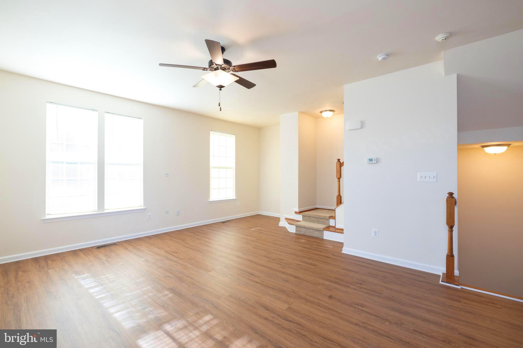 202 Fiesta Drive Stephenson, VA 22656 - Photo 5 of 33 a view of an empty room with wooden floor and a window