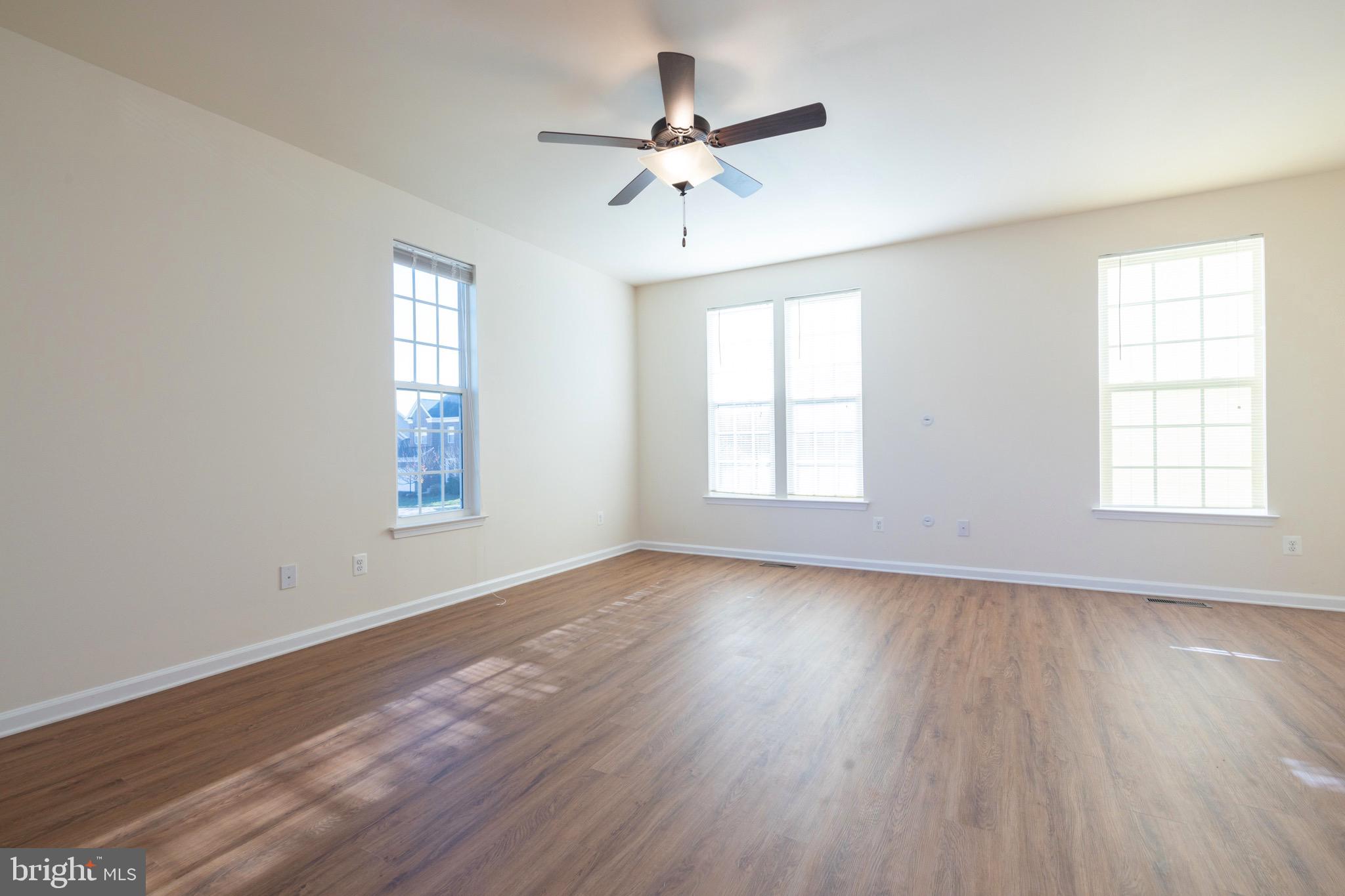 202 Fiesta Drive Stephenson, VA 22656 - Photo 6 of 33 a view of an empty room with wooden floor and a window