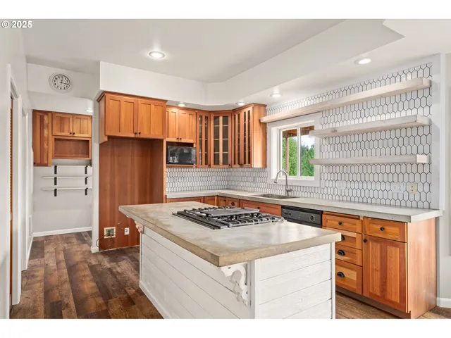 a kitchen with a stove a sink a refrigerator and wooden cabinets