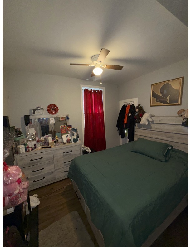 7916 South Normal Avenue Chicago, IL 60620 - Photo 6 of 6 a bedroom with a bed and a chandelier