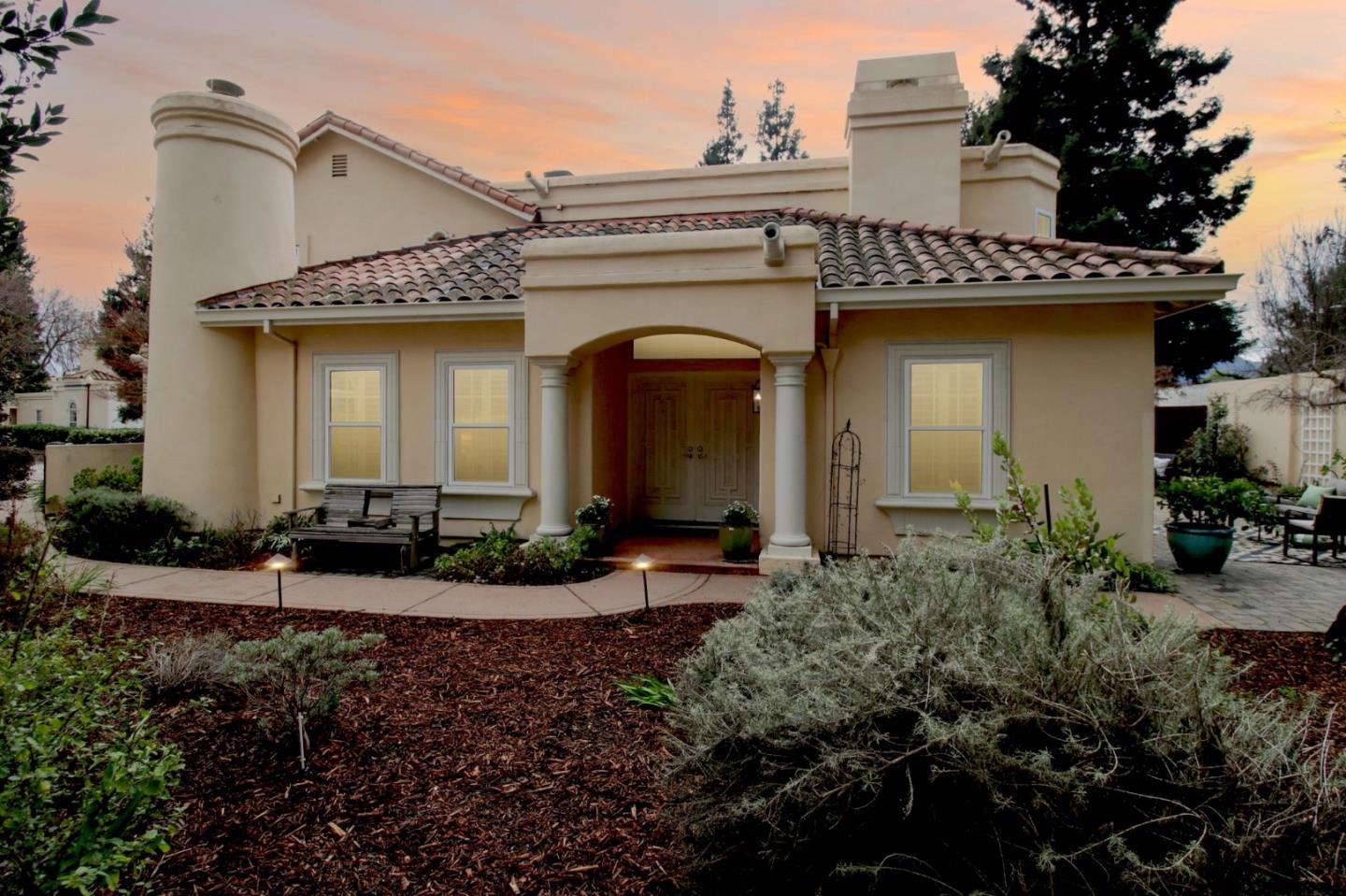 a front view of a house with garden