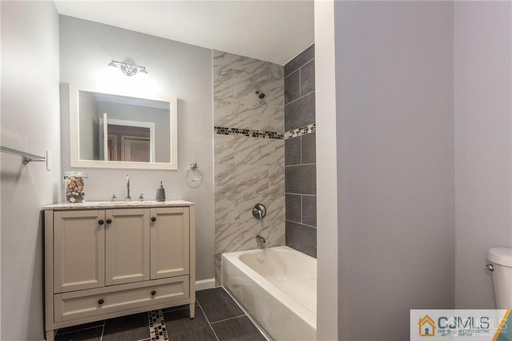 65 Tunison Road New Brunswick, NJ 08901 - Photo 20 of 22 a bathroom with a sink a toilet and shower