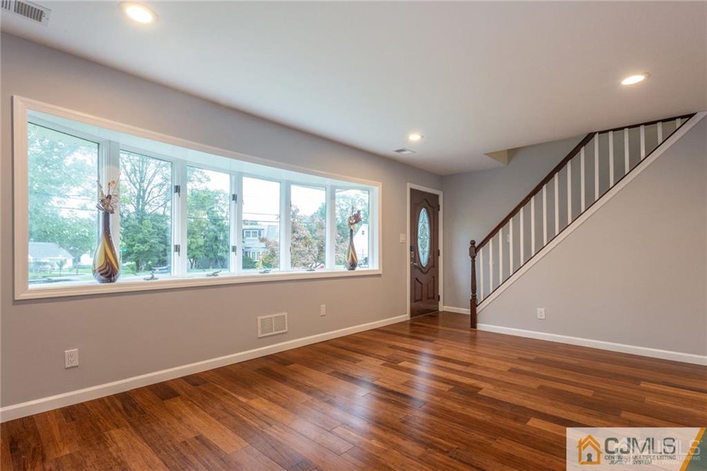 65 Tunison Road New Brunswick, NJ 08901 - Photo 2 of 22 a view of an empty room with wooden floor and a window