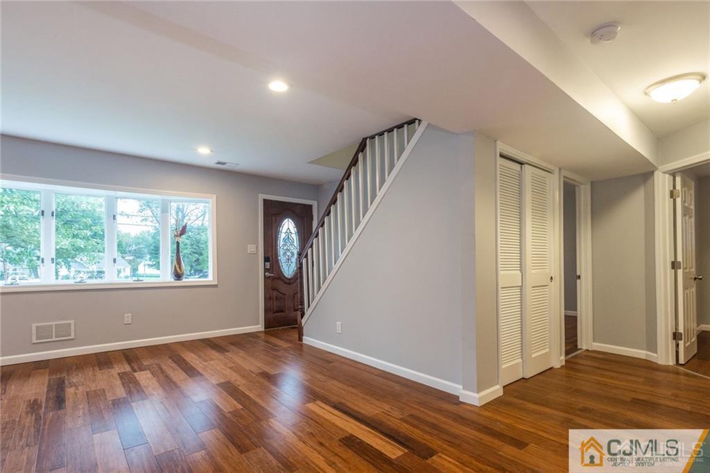 65 Tunison Road New Brunswick, NJ 08901 - Photo 3 of 22 a view of an empty room with wooden floor and a window
