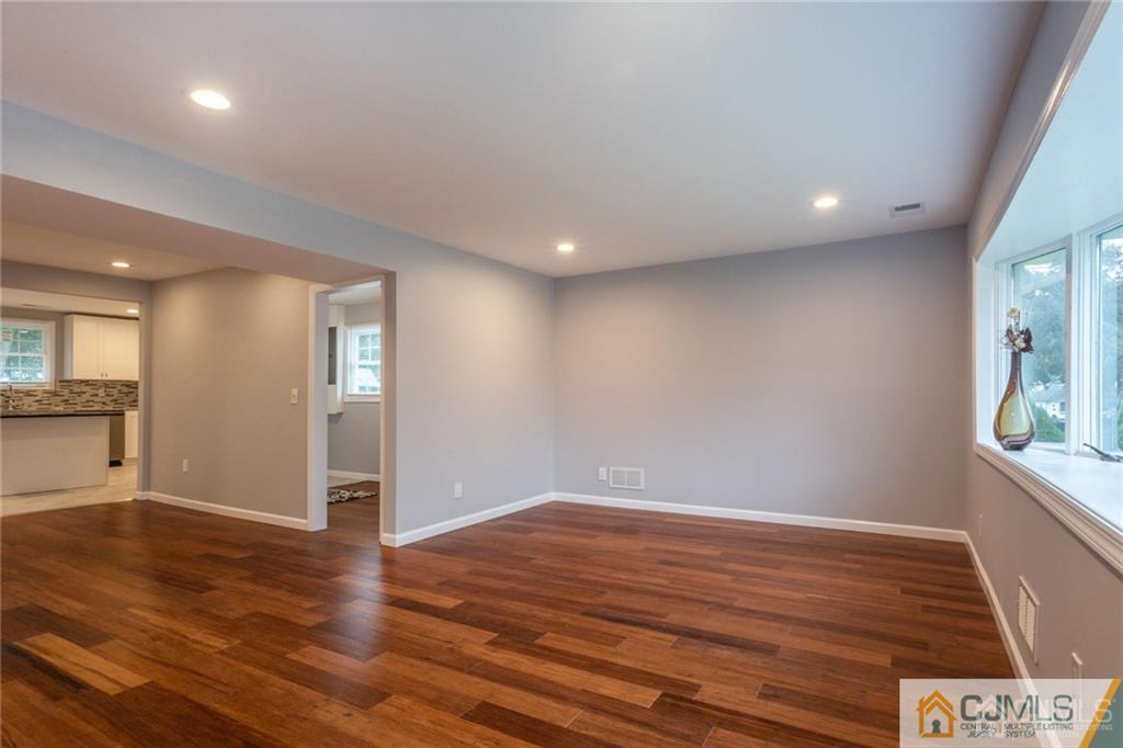 65 Tunison Road New Brunswick, NJ 08901 - Photo 5 of 22 a view of empty room with wooden floor and fan