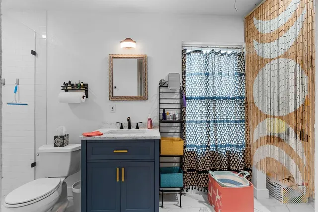 a bathroom with a sink toilet and shower