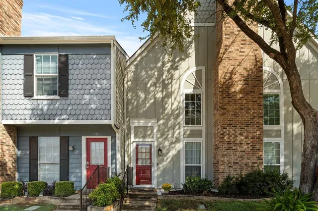 front view of a brick house with a yard