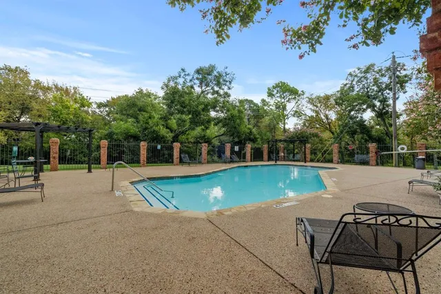 a swimming pool with outdoor seating and yard