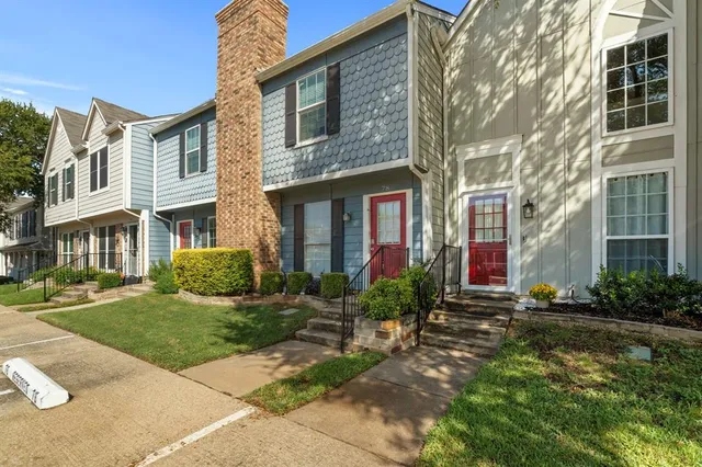 a front view of a brick house with a yard