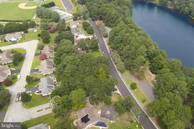 an aerial view of a houses with outdoor space and lake view