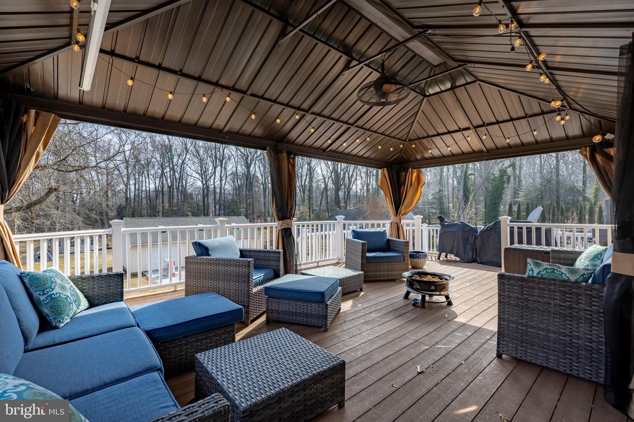 939 Shore Acres Road Arnold, MD 21012 - Photo 21 of 32 a view of a patio with couches chairs and wooden floor