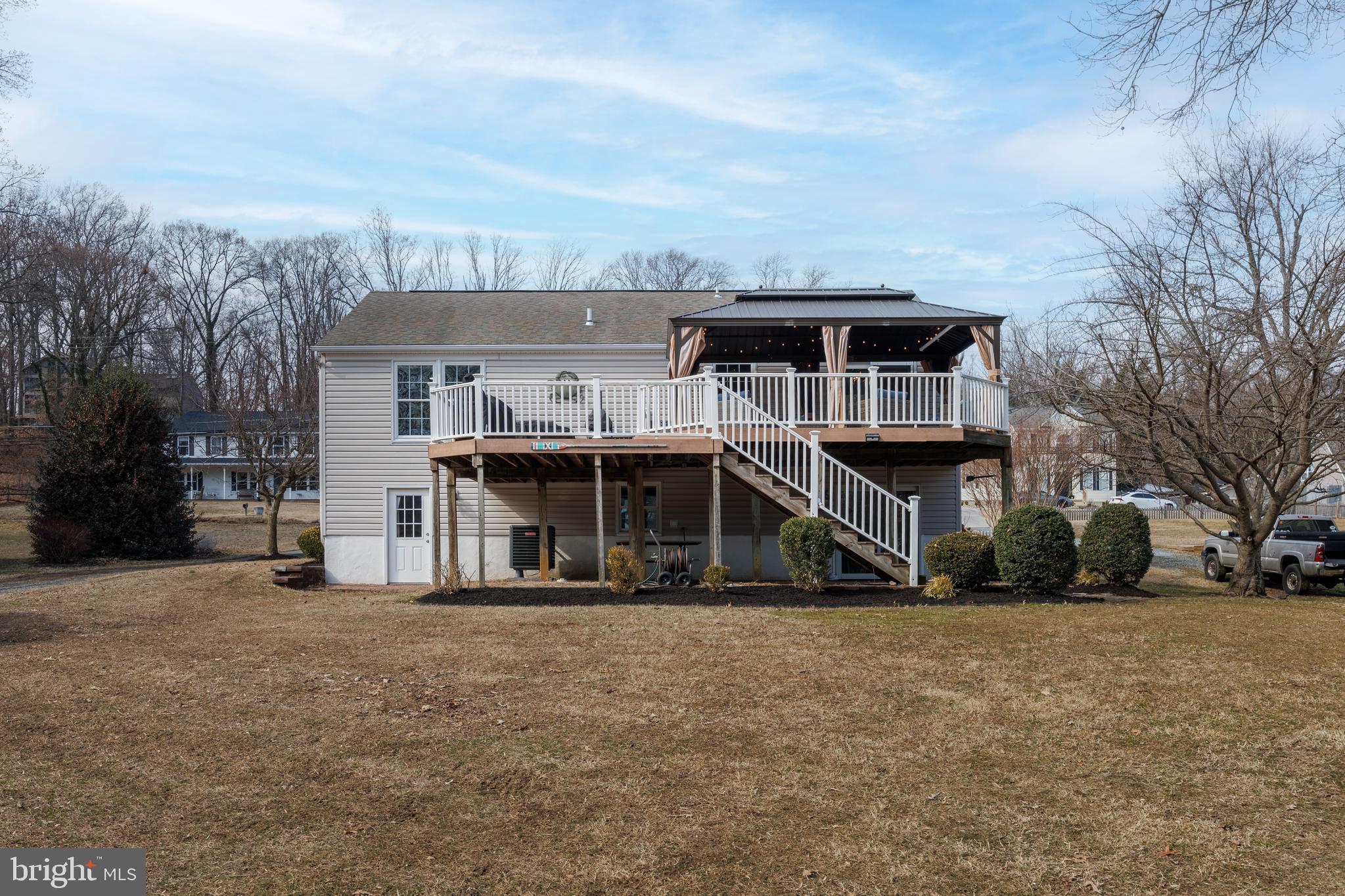939 Shore Acres Road Arnold, MD 21012 - Photo 23 of 32 a front view of a house with a big yard and large trees