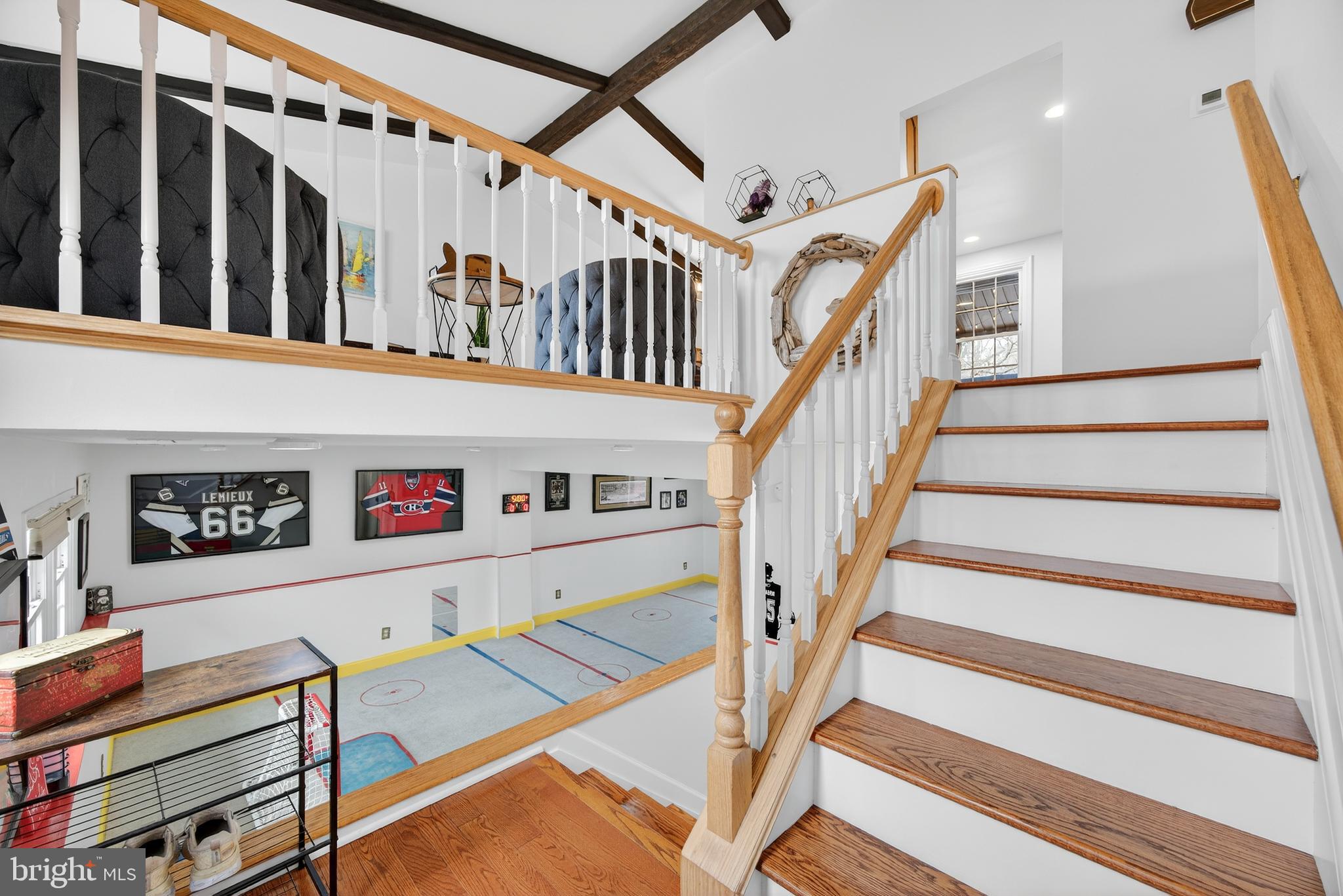 939 Shore Acres Road Arnold, MD 21012 - Photo 3 of 32 a view of staircase with lots of frames on wall and a ceiling fan
