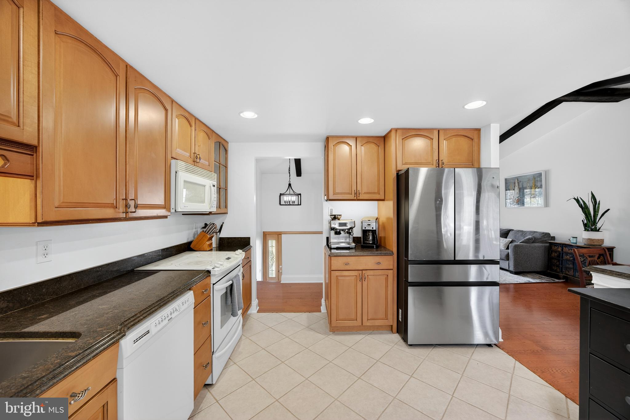939 Shore Acres Road Arnold, MD 21012 - Photo 7 of 32 a kitchen with granite countertop a refrigerator and a sink