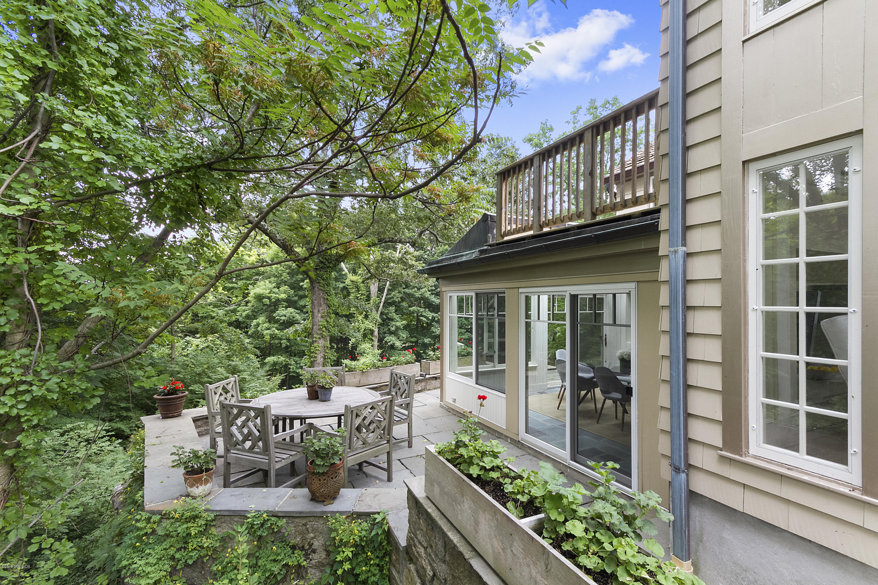 467 Laurel Road New Canaan, CT 06840 - Photo 22 of 29 a view of a chair and table in backyard of the house