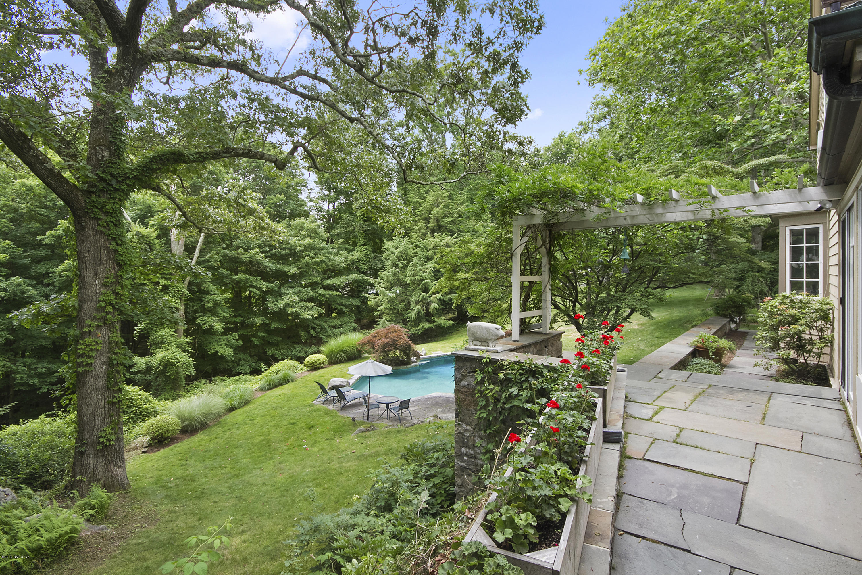 467 Laurel Road New Canaan, CT 06840 - Photo 24 of 29 a view of a chair and table in the garden
