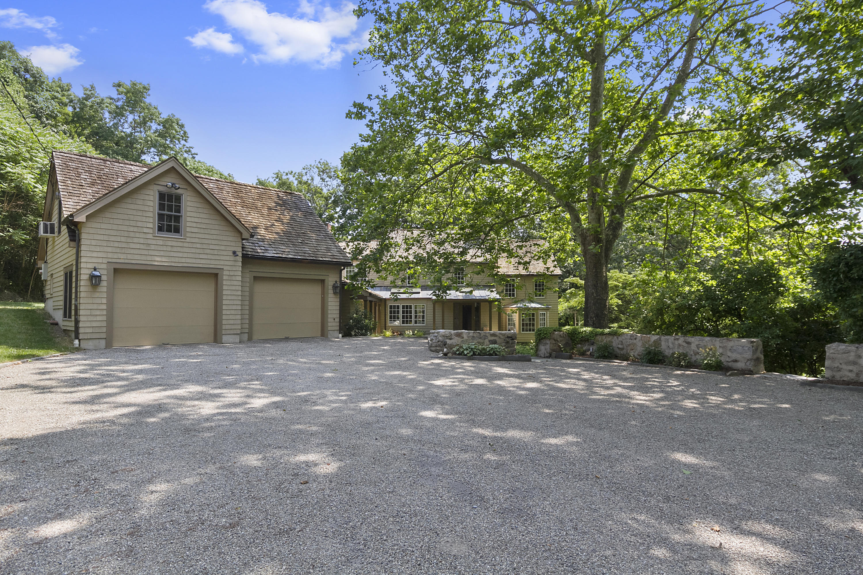 467 Laurel Road New Canaan, CT 06840 - Photo 28 of 29 a view of a house with a yard and garage