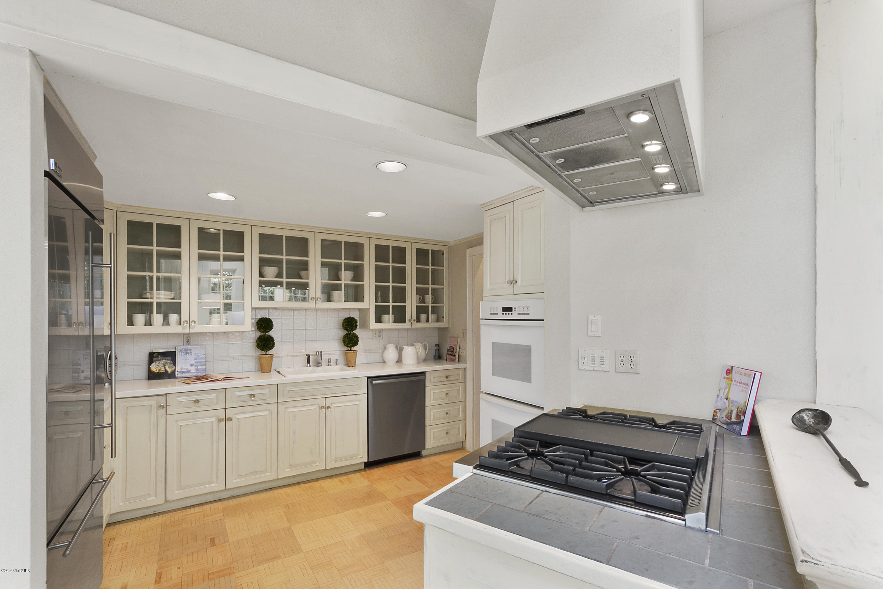 467 Laurel Road New Canaan, CT 06840 - Photo 10 of 29 a kitchen with a sink and wooden floor