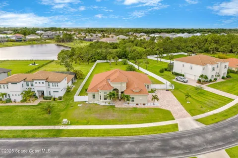 an aerial view of residential houses with outdoor space and swimming pool