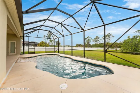 a view of a swimming pool with a patio