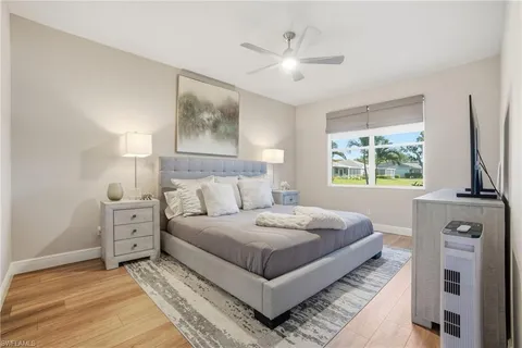 a bedroom with a large bed and a window