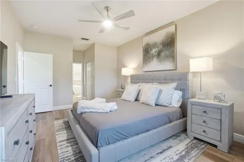 a bedroom with a large bed and a chandelier