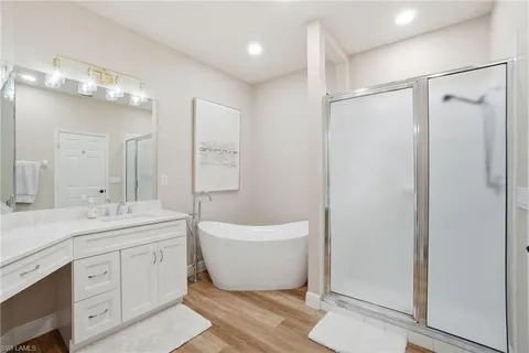 a spacious bathroom with a double vanity sink a mirror and a shower