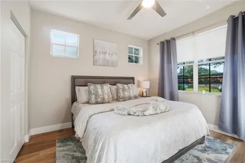 a bedroom with a large bed and a window