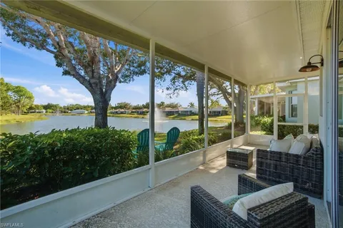 a view of a balcony with lake view and a potted plant