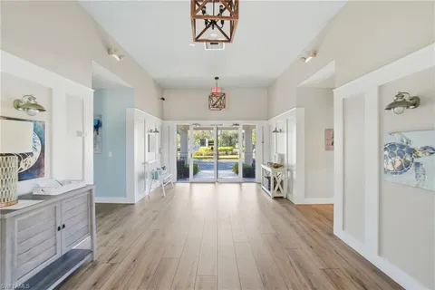 a open kitchen with white cabinets and wooden floor