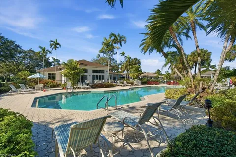 a view of a house with pool and chairs
