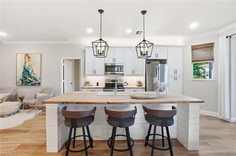 a kitchen with a dining table and chairs