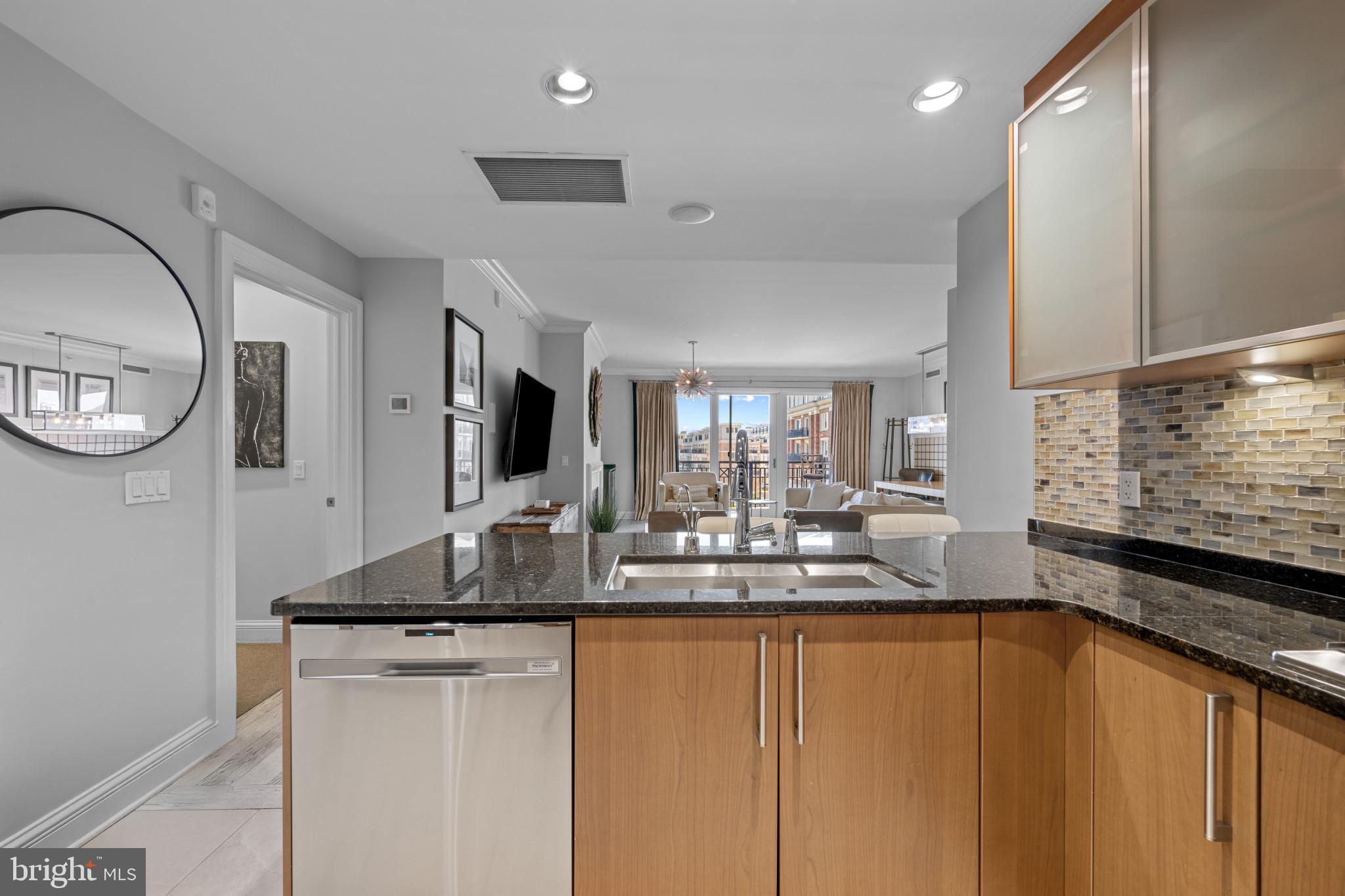 801 Key Highway, Unit 458 Baltimore, MD 21230 - Photo 15 of 48 a kitchen with stainless steel appliances granite countertop a sink and a refrigerator