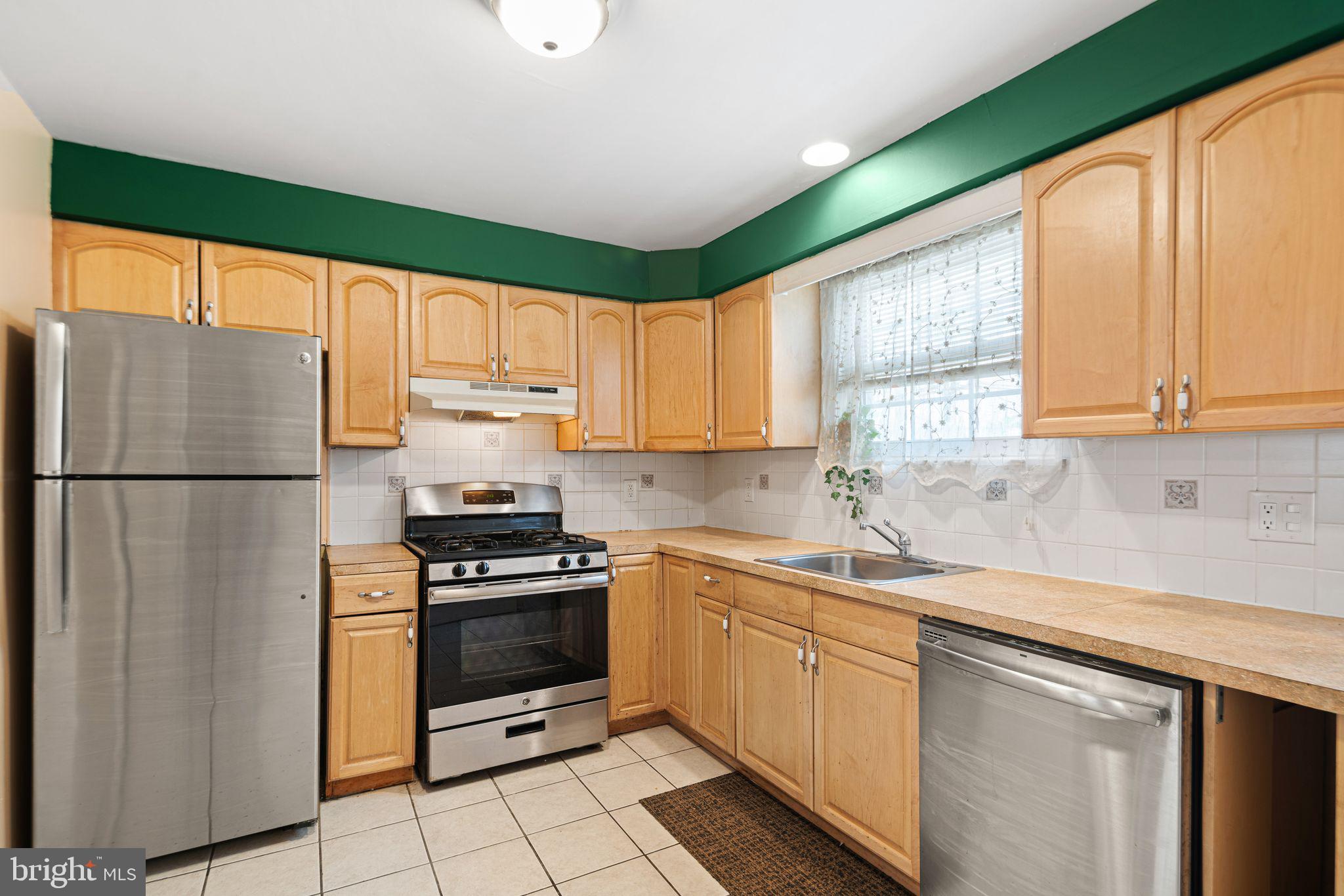 1925 South Alder Street Philadelphia, PA 19148 - Photo 3 of 13 a kitchen with a sink a refrigerator and window