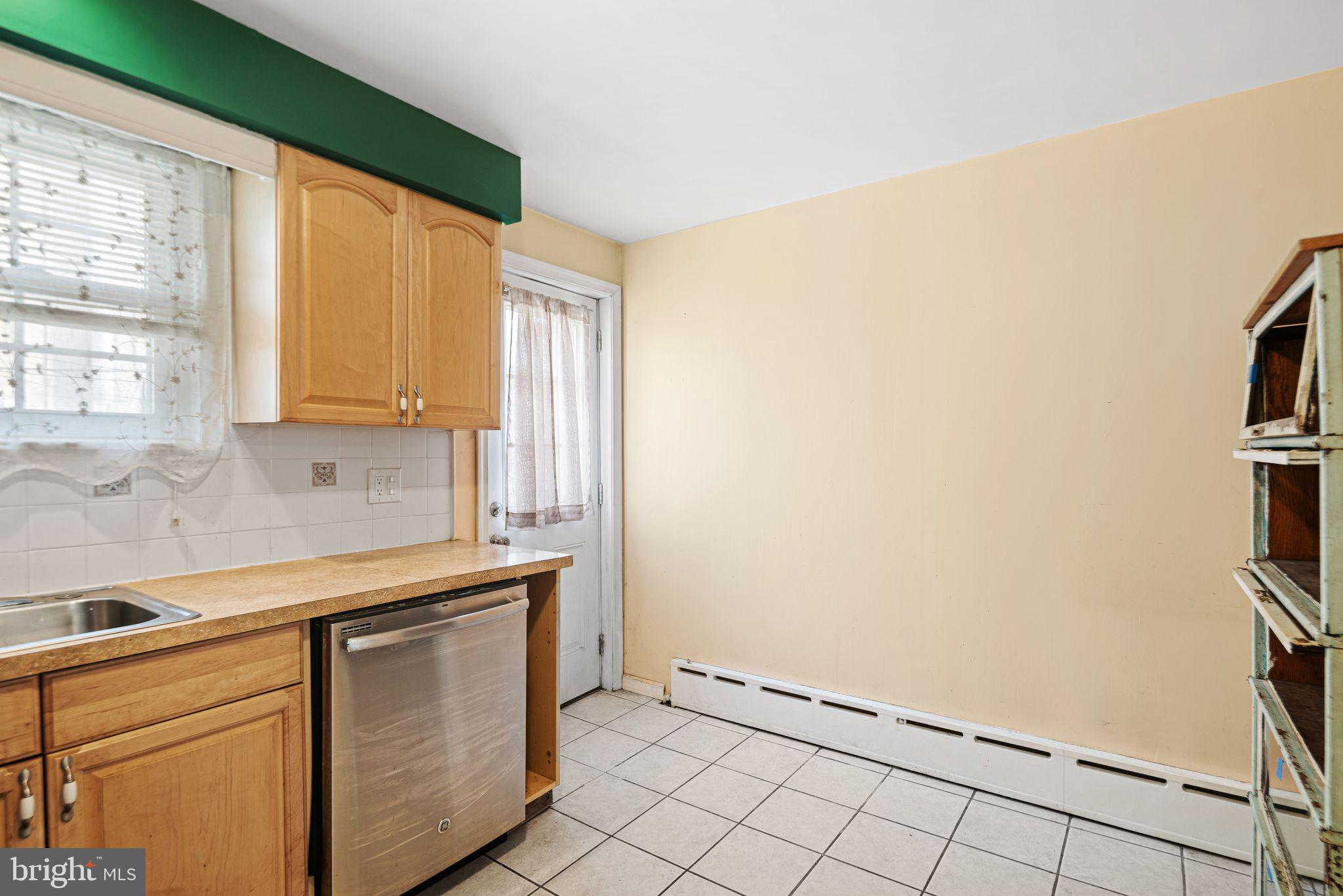 1925 South Alder Street Philadelphia, PA 19148 - Photo 4 of 13 a kitchen with granite countertop cabinets stainless steel appliances a sink and a window
