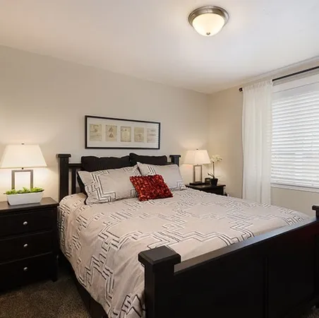 a bedroom with a bed and a lamp