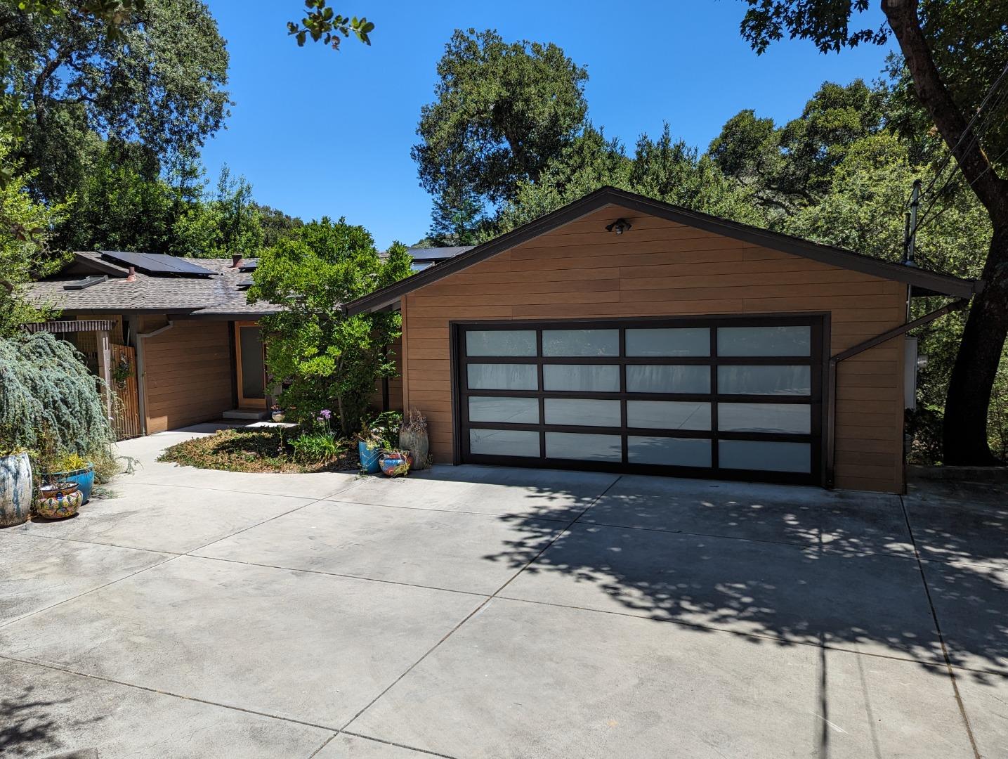 a front view of a house with a yard and a garage