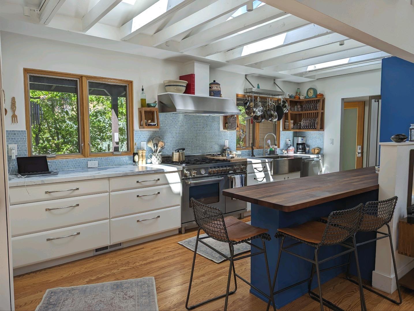 113 Foxwood Road Portola Valley, CA 94028 - Photo 4 of 9 a kitchen with a table chairs and wooden floor
