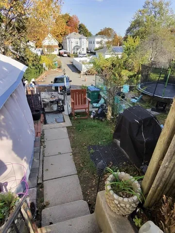 a kitchen with stainless steel appliances granite countertop a sink dishwasher and a microwave with wooden floor