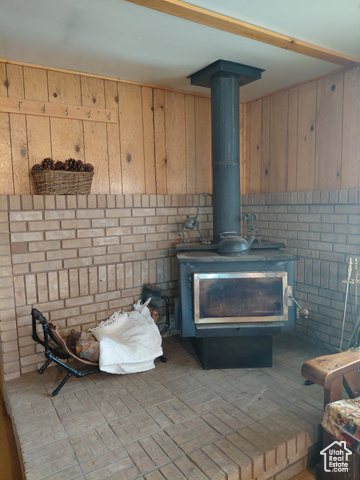 913 East 5300 North Helper, UT 84526 - Photo 12 of 29 Room details featuring wooden walls and a wood stove