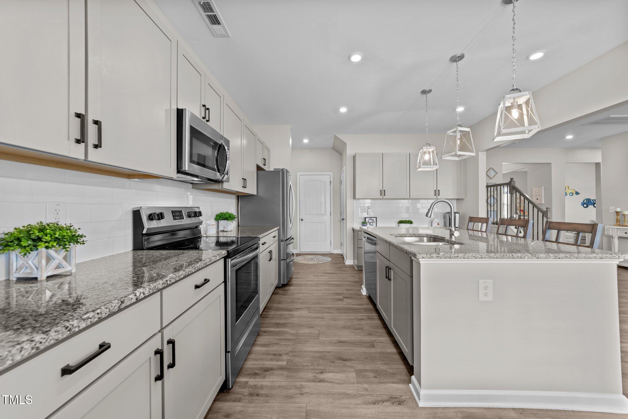 3613 Cross Timber Lane Raleigh, NC 27603 - Photo 14 of 33 a large kitchen with stainless steel appliances lots of counter space and a sink