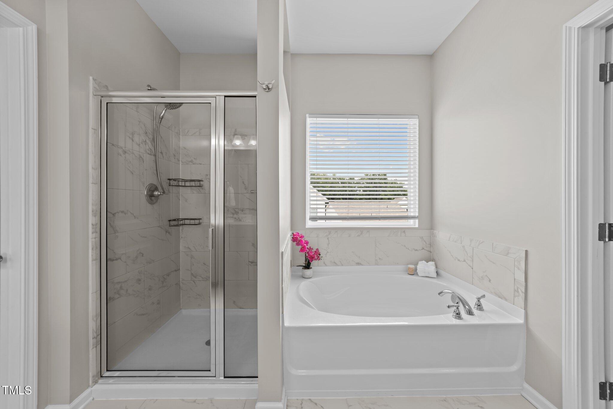 3613 Cross Timber Lane Raleigh, NC 27603 - Photo 24 of 33 a bathroom with a bathtub and a shower