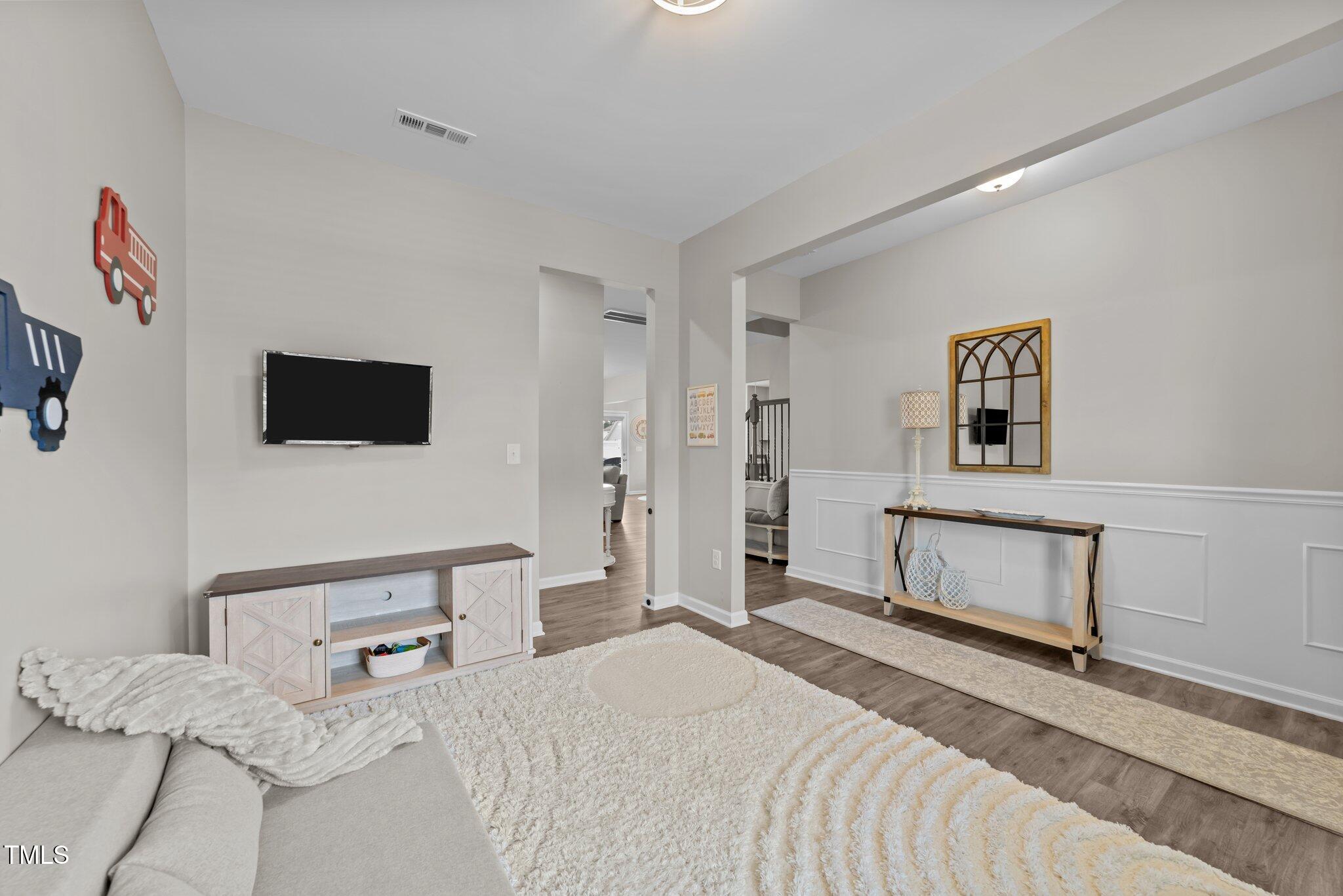 3613 Cross Timber Lane Raleigh, NC 27603 - Photo 7 of 33 a bedroom with a bed and a flat screen tv
